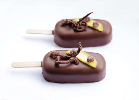 Chocolate glazed peach ice cream with chocolate decorationの写真素材