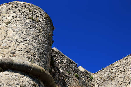 Ancient fort castle building stone wall and tower on blue sky backgroundのeditorial素材
