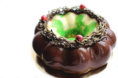 Christmas wreath cake with cranberries, mirror glaze and green coral lace on white background