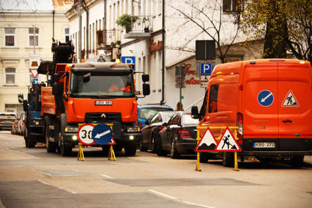 Road blocked by big bright color construction transport for road works