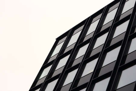 Modern with glass wndows building top corner on white sky background