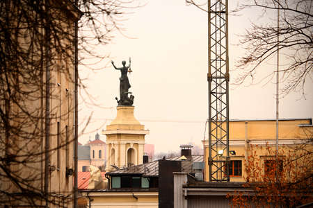 Vilnius city energy museum woman with lantern elektra statue from behind in autumnのeditorial素材