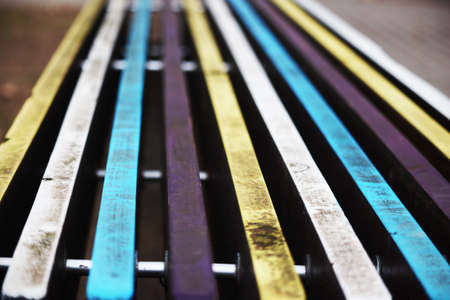 Colorful dirty painted bench planks bokeh blurred backgroundの写真素材