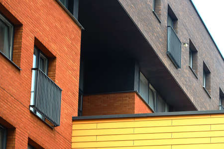 Modern building triple color red yellow and grey walls with windows