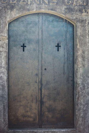 Old metal door with cross holes decorationsの写真素材