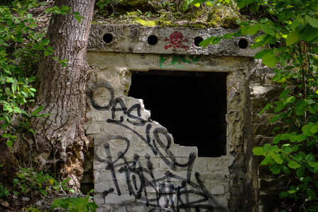 Vilnius, Lithuania - 07062020: Hidden catacomb with wall art graffiti writings in forestのeditorial素材