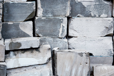 Gray and white bricks stackef like wall with gaps and holesの写真素材