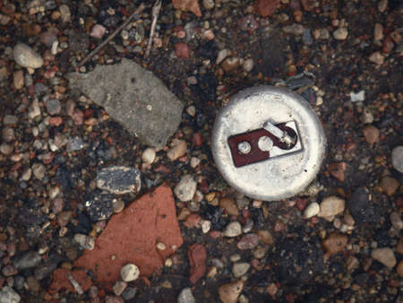 Old corroded steel metal switch with lever lying on ground in trash with broken red brick parts and...