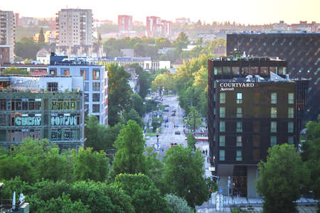 Vilnius, Lithuania - June 06 2022: Lively street view on business center buildings and green trees...