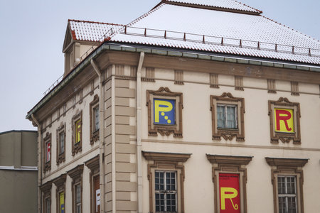 Vilnius, Lithuania - December 2021: Radvilai palace facade in winter with different R letters in windows and snow on the roofのeditorial素材