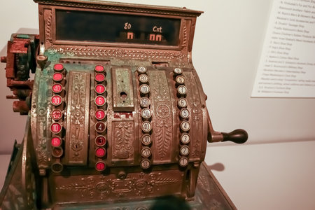 Vintage metal cash register with round buttons with numbers in a sepia toneの写真素材