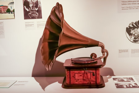 Vintage gramophone of bronze and wood with deep shadows side view