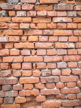 Background of wide old red brick wall texture. Home or office design backdrop with washed out red...