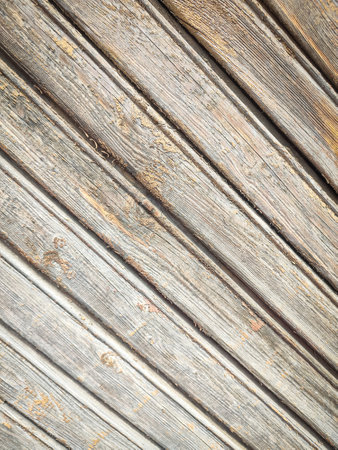 Texture of a wooden plank fence with diagonal wood strips, gray brown wooden wall texture backdropの写真素材