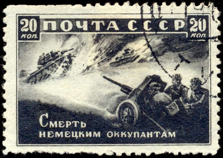 SOVIET UNION - CIRCA 1942: A stamp printed by the Soviet Union Post is entitled Death to German Invaders!, circa 1942. It shows Russian artillery men shooting at fascist tanks.のeditorial素材