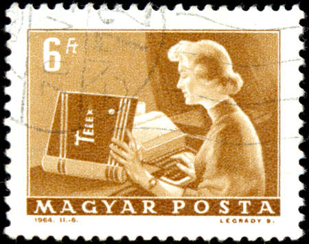 HUNGARY - CIRCA 1964: a stamp printed by Hungary shows Telex operator. Series Post and Reporting. Circa 1964.のeditorial素材