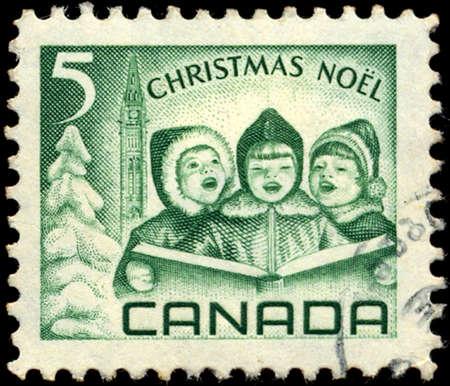 CANADA - CIRCA 1967: a stamp printed in the Canada shows Singing Children and Peace Tower, Ottawa, Christmas, circa 1967のeditorial素材