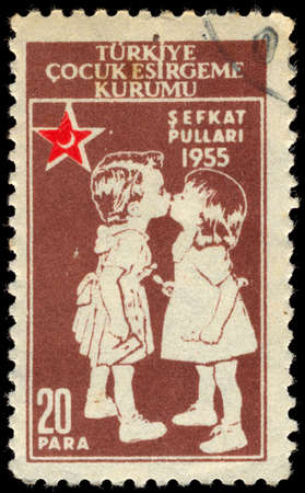 TURKEY- CIRCA 1955: A stamp printed by Turkey, shows kissing children, circa 1955のeditorial素材