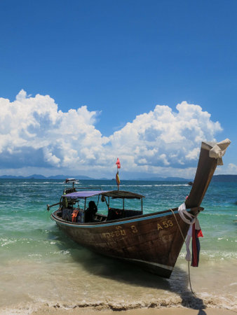 Long-tailed boats moored for tourists At Railay Beach, Krabi, Thailand, the backdrop is the blueh harmonize the deep blue sky.の写真素材