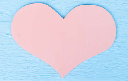 pastel pink heart on blue wood background with space fot textの写真素材
