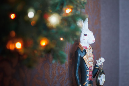 Christmas bright decoration with tree branch, garland and rabbitの写真素材