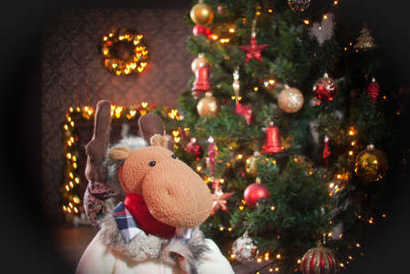 Christmas deer and fireplace, tree and garland backgroundの写真素材