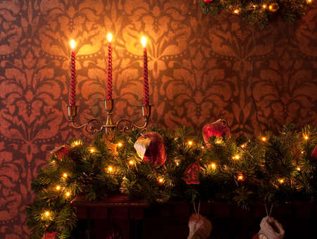 Christmas decoration with candles, garland and tree branchの写真素材