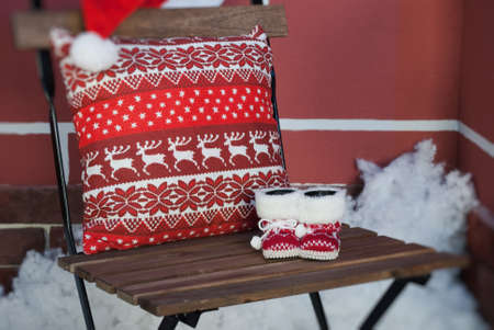 Christmas decoration with pillow, baby's bootees and snowの写真素材