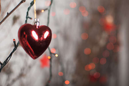 Red heart on a dark gray background with garlandの写真素材