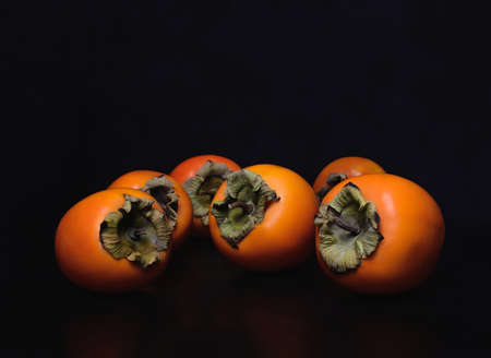 Persimmon black background. Juicy persimmon.の写真素材