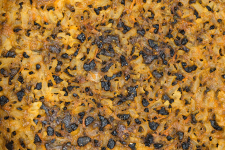 The texture of overcooked and burned rice on the pot bottom