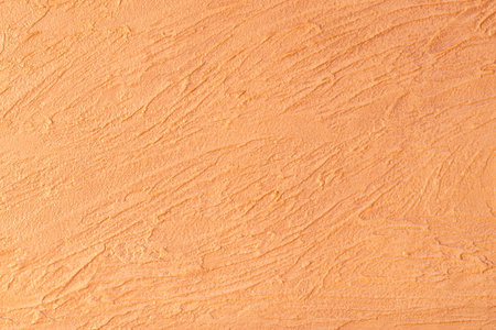 Orange lined plaster texture. Decorative plaster. Wall decor background