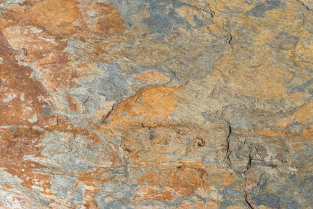 The texture of rough stone wall covered with rust as a solid background