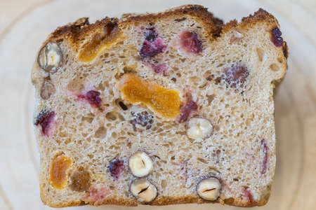 Rye bread slice with cranberry raisins, apricot and nuts, flat lay top viewの写真素材