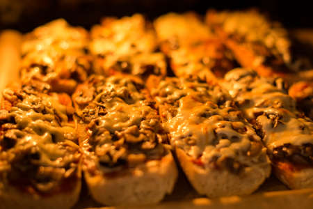 A typical oven-baked Polish zapiekanka (toasted baguette with white mushrooms and cheese) also known as Polish pizza.の写真素材