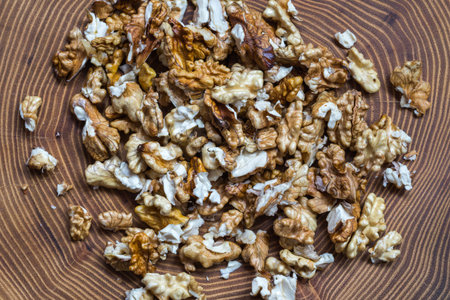 The freshly dehulled walnut kernel on wooden acacia tree slice top view.の写真素材