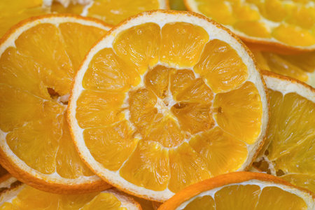 Cross-section of the dried oranges slices showing the pattern of the flesh. Food background.