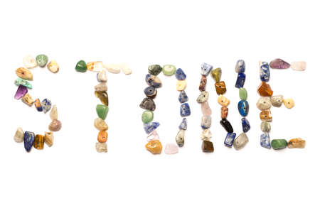 Word stone made of colorful small rock beads isolated on white background.の写真素材
