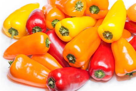 Mixed mini bell peppers on white background. Sweet paprika assortment.