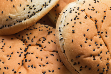 A selective focus on nigella seed-topped wheat burger buns.