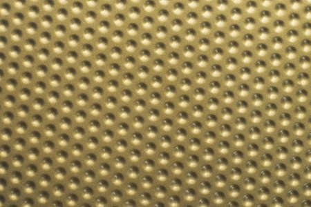 Golden textured pattern of the baking tin bottom. Seamless metal sheet as background.の写真素材