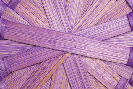 Closeup shot of the bottom of a woven basket made of natural material.