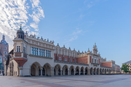 Cracow, Poland - 4th of July 2021: Main square of the old town with famous Cloth Hall (called Sukkiennice in Polish) in the morning light.のeditorial素材
