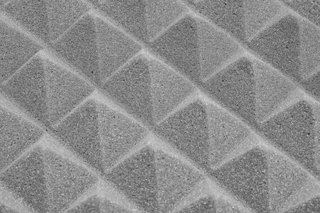 The pyramid structure of the professional acoustic foam. Grey background texture