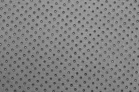Seamless perforated black leather geometric pattern for background, banner, or coverの写真素材