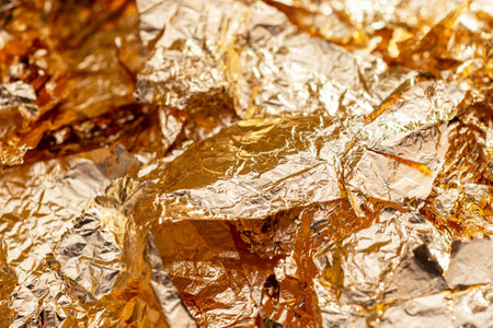 Gold foil flakes. Art and craft supply. Decorative material. Metallic backgroundの写真素材