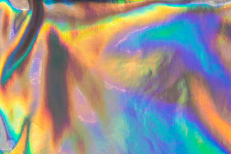 Rainbow-coloured shimmering texture. Holographic pattern. Abstract neon background