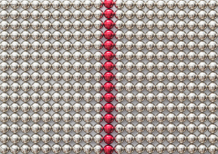 Full frame of chrome metal magnet balls divided by the red lineの写真素材