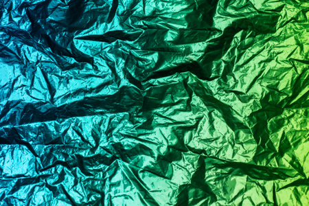 Metallic aqua green color scheme. Bicolor crumpled foil as the background textureの写真素材