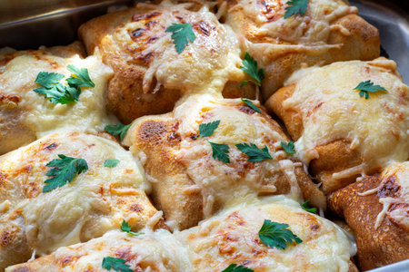 A baking tray full of ready to be eaten pancake envelopesの写真素材